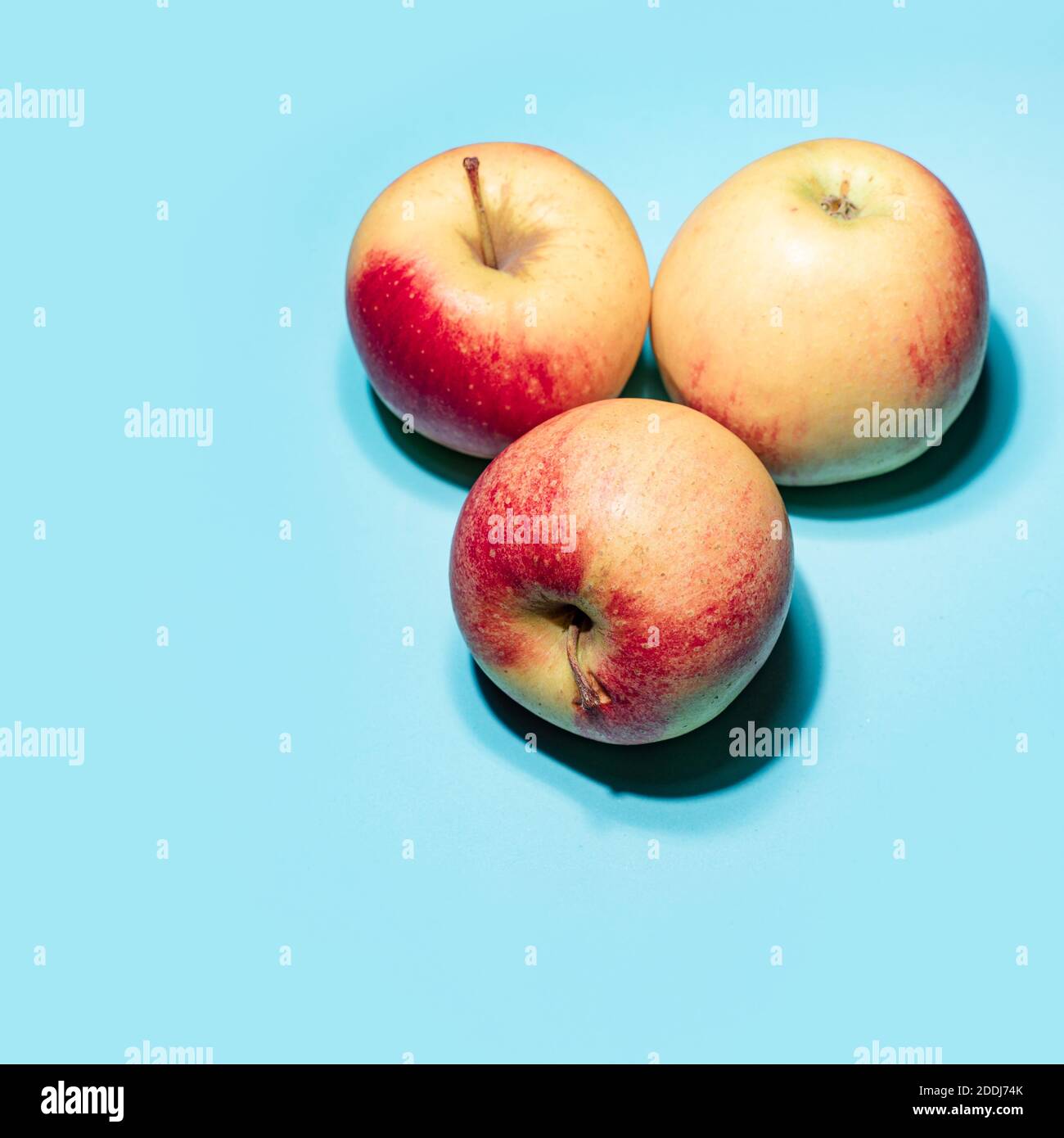 Apples on blue background art image Stock Photo