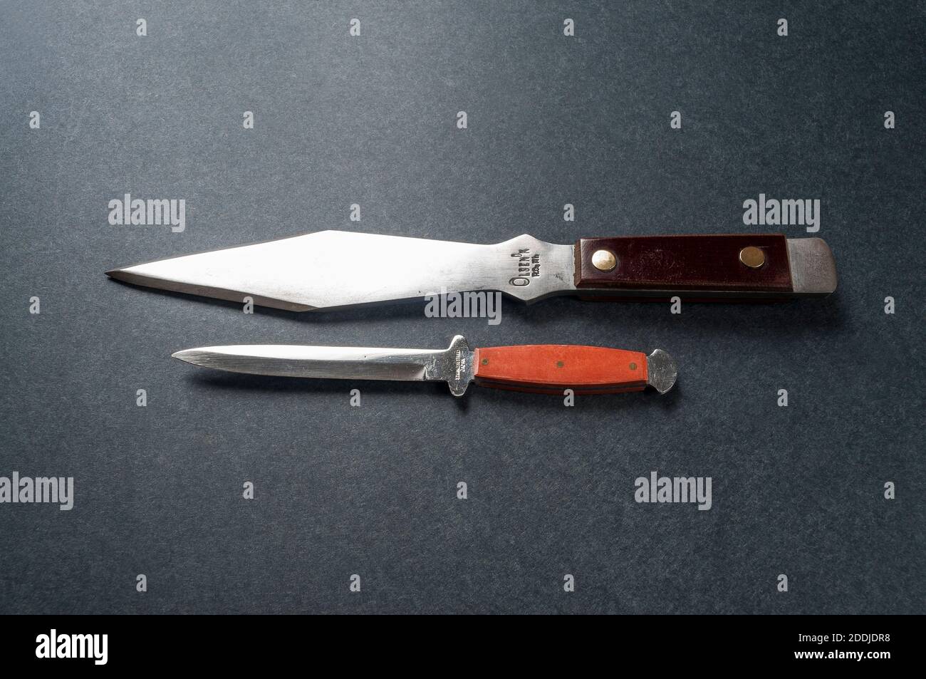 https://c8.alamy.com/comp/2DDJDR8/two-different-vintage-throwing-knives-the-larger-is-an-olsen-ok-throwing-knife-the-smaller-is-imprinted-with-stainless-japan-2DDJDR8.jpg