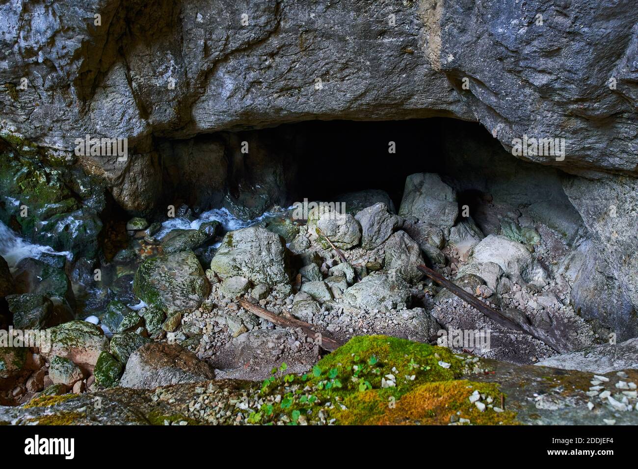 Underground river and waterfall on mossy boulders in a cave Stock Photo ...