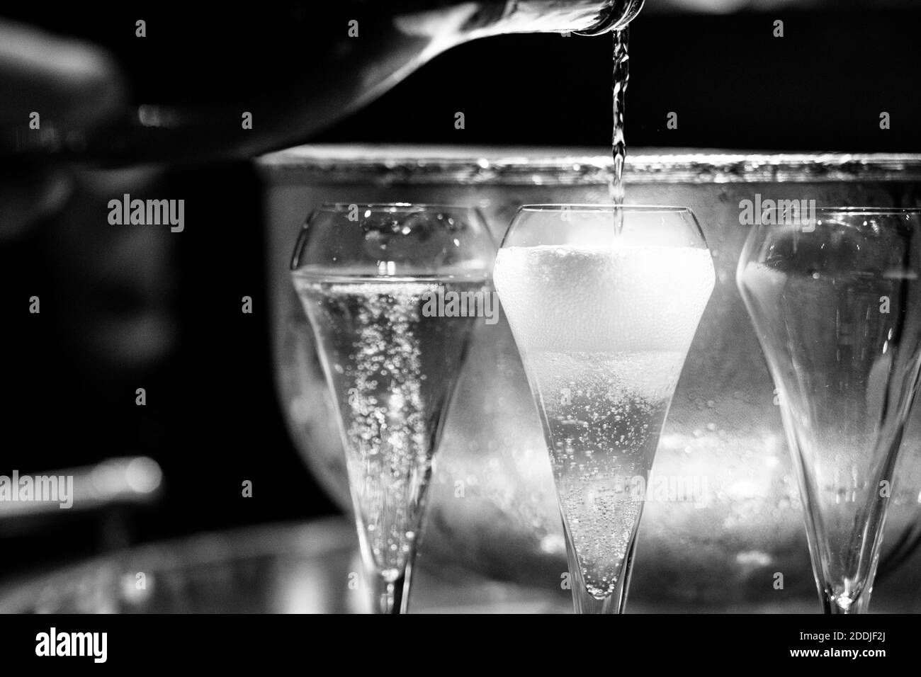 Prosecco is poured in to the glass as the bubbles rise to the top of