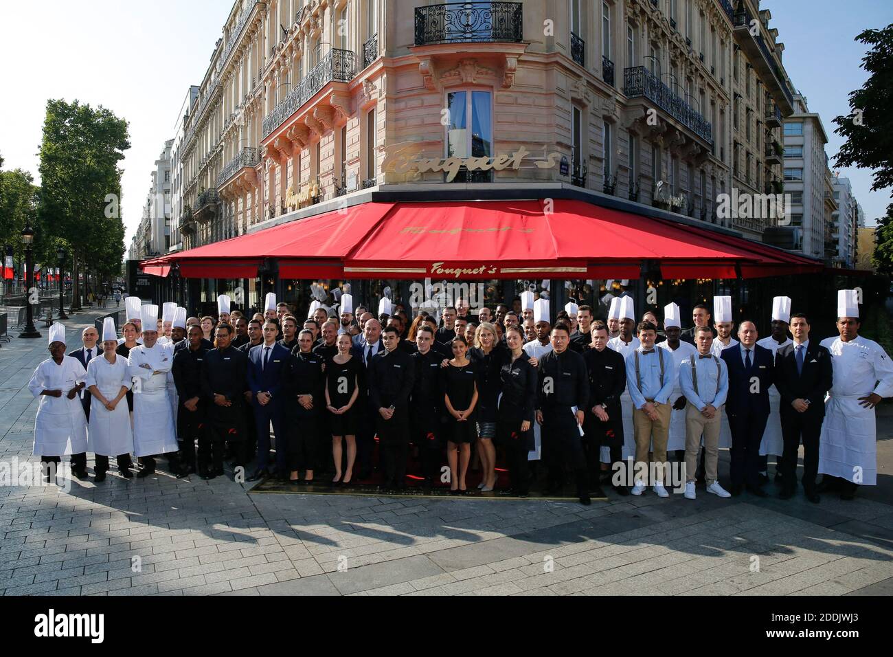 Géraldine Dobey, Managing Director Hotel Barriere Le Fouquet's Paris poses  outside the restaurant with the Employees - After several months of work, Le  Fouquet's Paris will reopen its doors on July 14th.