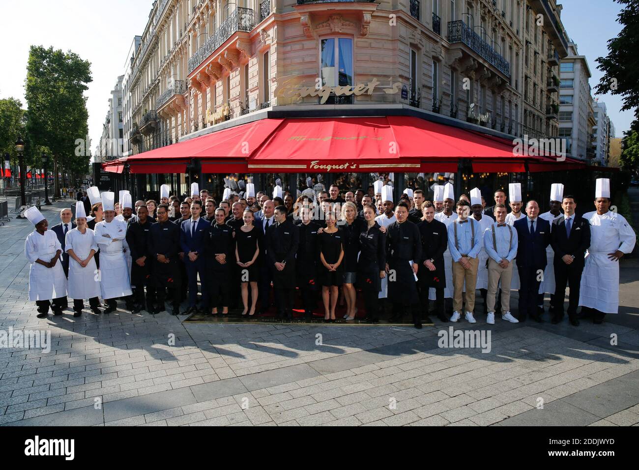 Géraldine Dobey, Managing Director Hotel Barriere Le Fouquet's Paris poses  outside the restaurant with the Employees - After several months of work,  Le Fouquet's Paris will reopen its doors on July 14th.