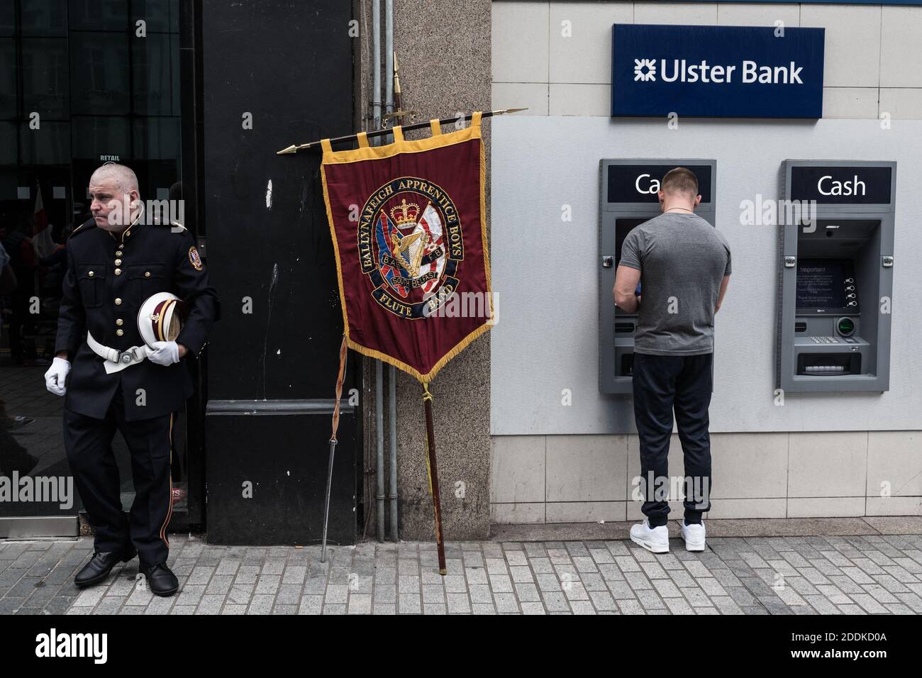 A man withdraws money from Ulster Bank cash machine while a participant