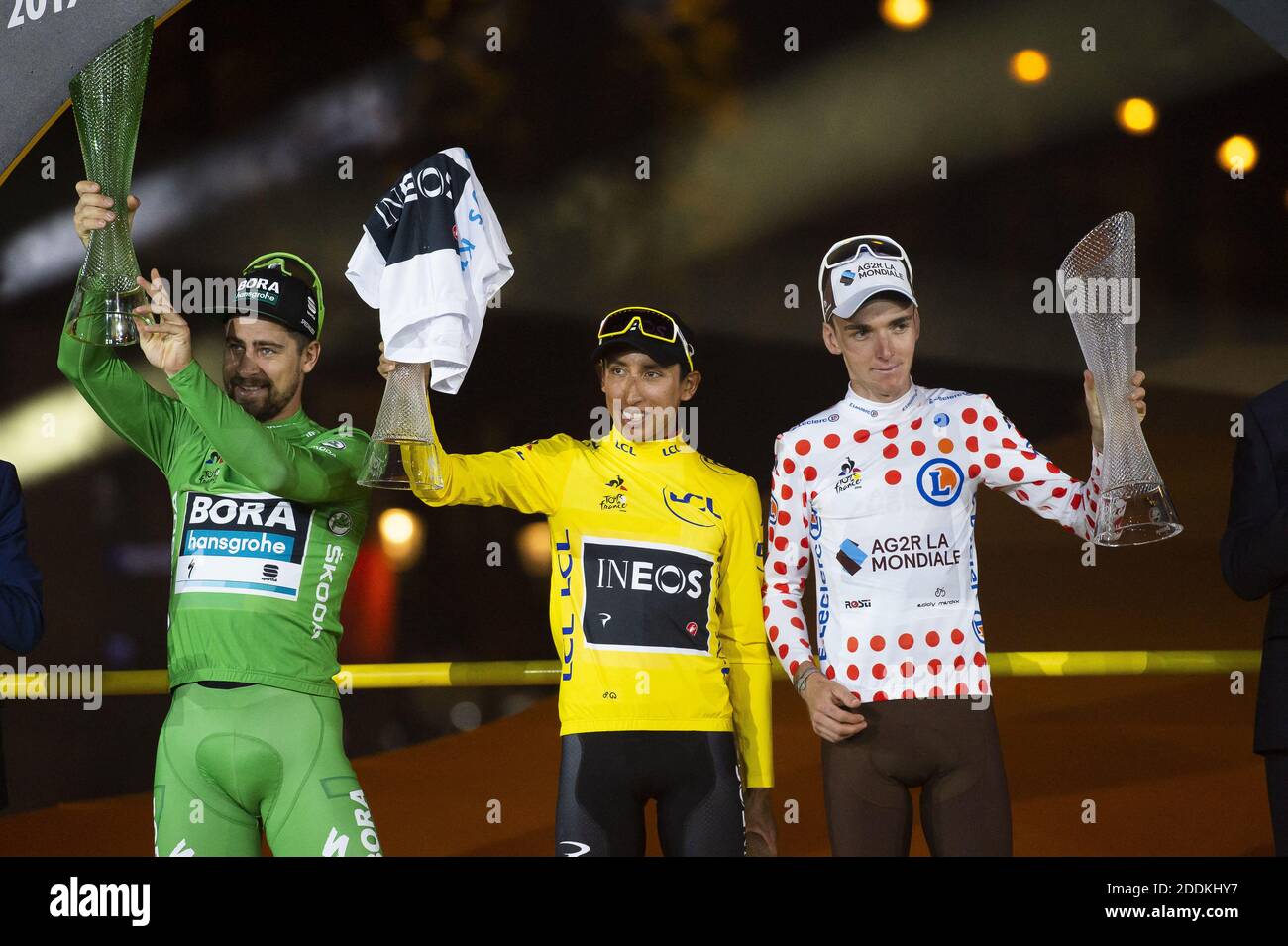 Slovakia's Peter Sagan, wearing the best sprinter's green jersey (L),  Colombia's Egan Bernal, wearing the overall leader's yellow jersey (C) and  France's Romain Bardet, wearing the best climber's polka dot jersey  celebrate