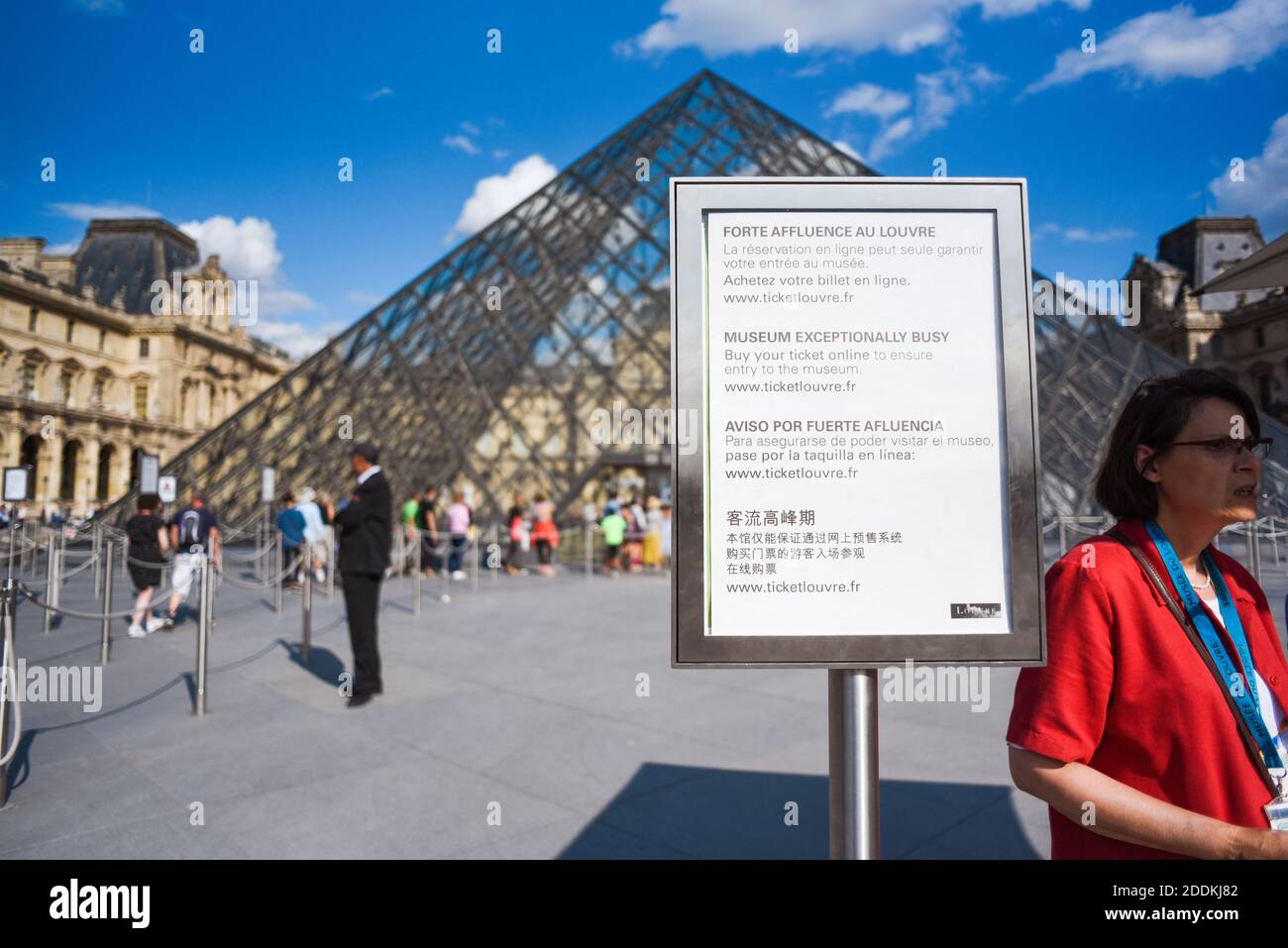A sign stands in front of the "la Pyramide du Louvre" on July 31 2019 in  Paris, France. Anyone planning a visit to Paris' Louvre museum has been  warned to book in