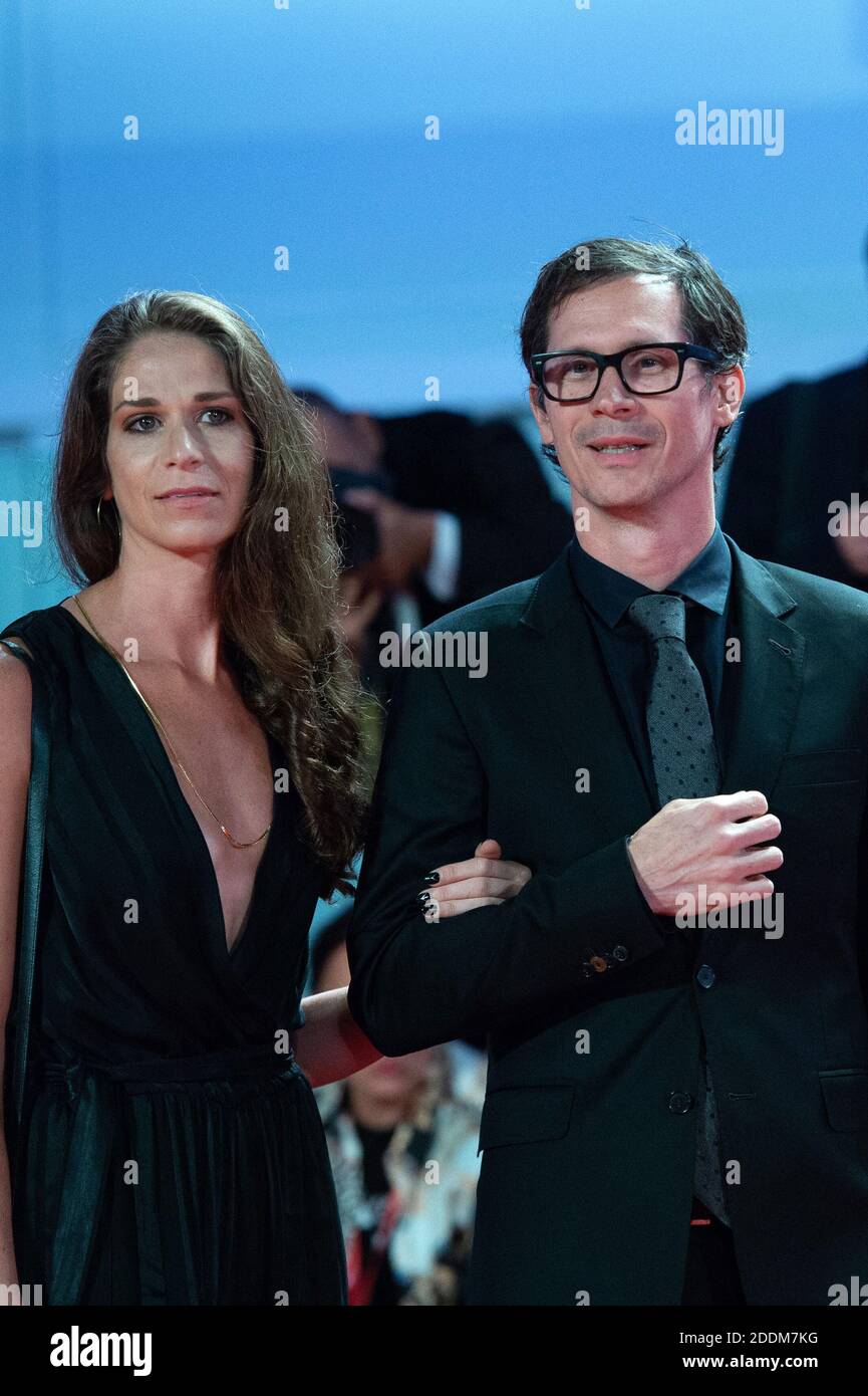 Sean Evans and guest attending the Roger Waters Us + Them Premiere as