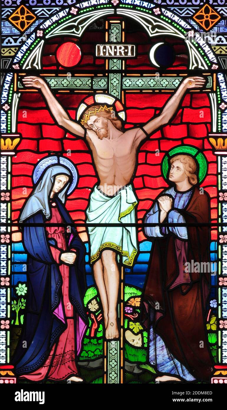 Crucifixion of Jesus, with Mary and John, detail of stained glass window, by Frederick Preedy, 1867, Old Hunstanton, Norfolk, England Stock Photo