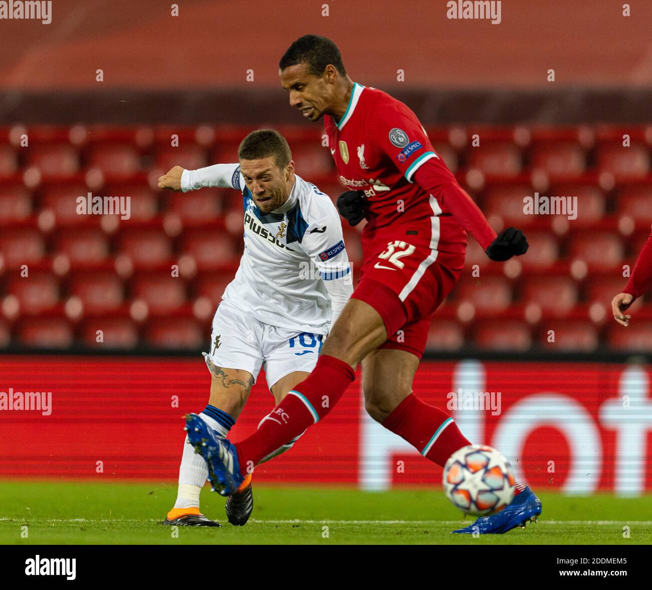 Liverpool. 26th Nov, 2020. Atalanta's Alejandro Gomez (L) shoots as Liverpool's Joel Matip attempts to block during the UEFA Champions League Group D match between Liverpool FC and Atalanta BC at Anfield in Liverpool, Britain, on Nov. 25, 2020. Credit: Xinhua/Alamy Live News Stock Photo