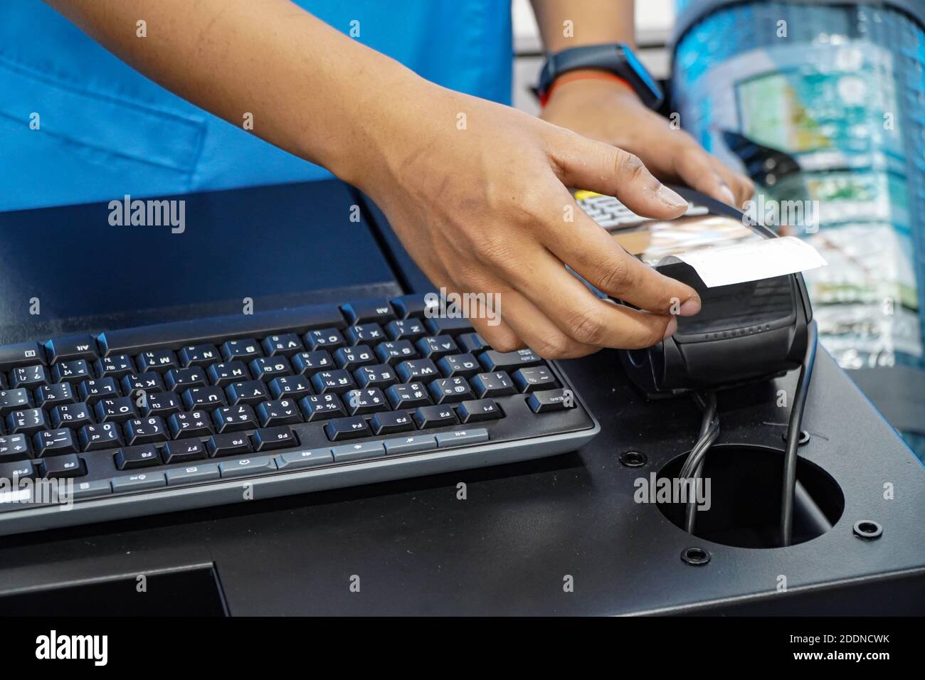 Hand holding the receipt from the credit card swipe machine .Pay with a