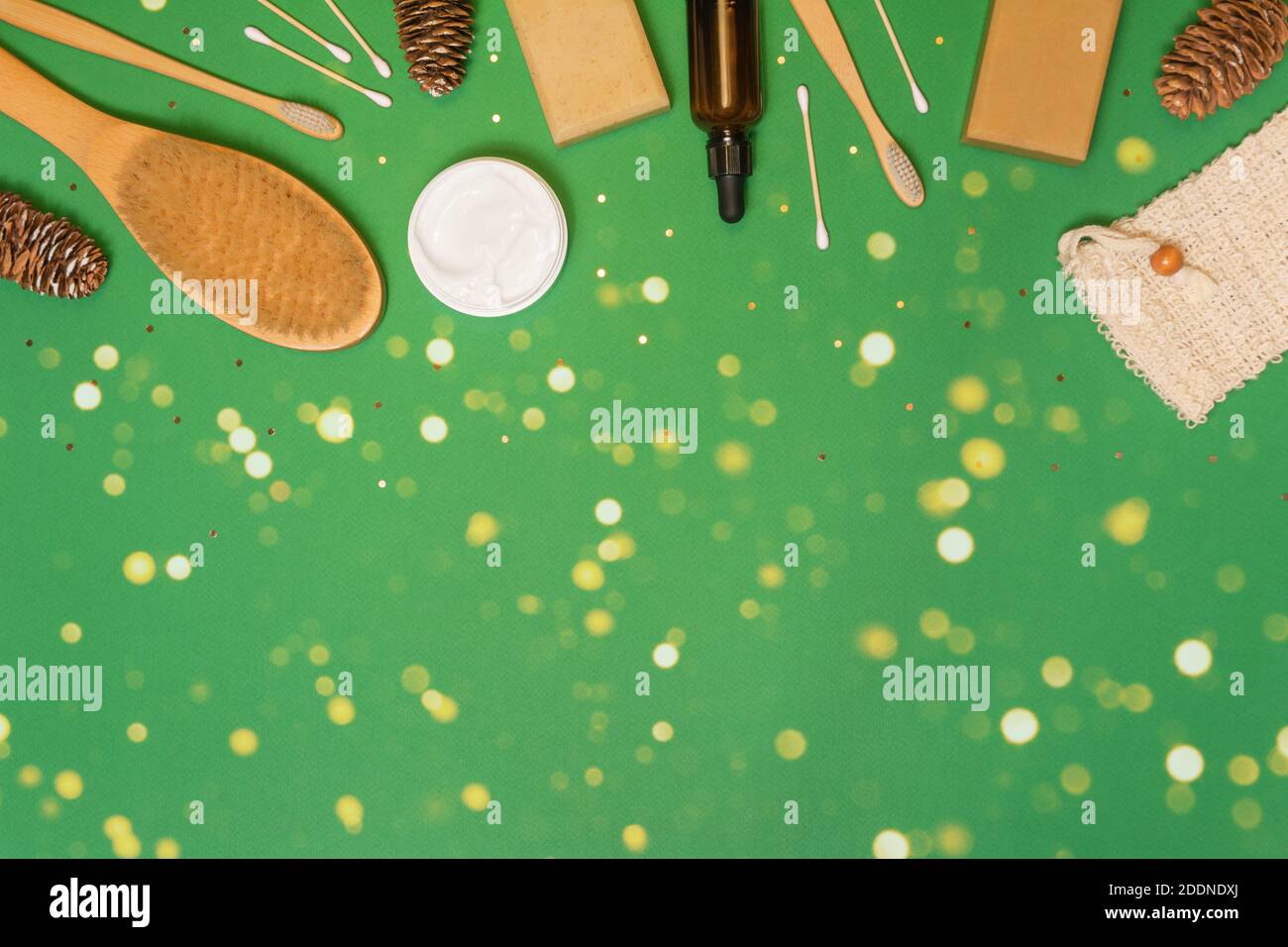 Natural zero waste cosmetics for healthy skin and face on green background with confetti and lights. Eco friendly product. Flat lay, copy space Stock Photo