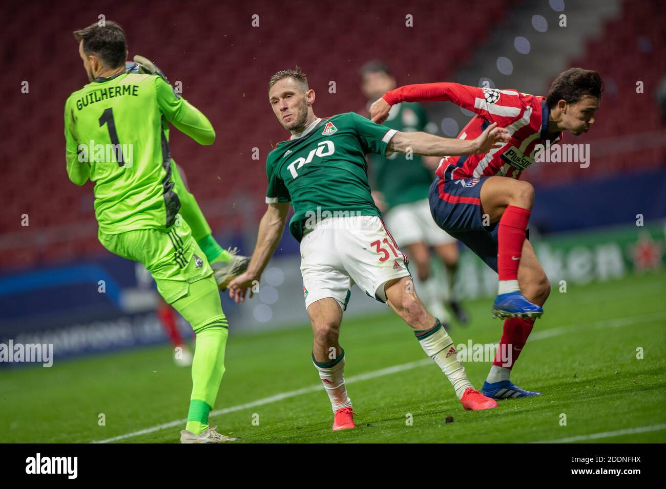 Madrid, Spain. 25th Nov, 2020. Atletico Madrid's Joao Felix (R) vies with Lokomotiv's Maciej Rybus (C) and Guilherme Marinato during the UEFA Champions League Group A football match between Atletico Madrid and Lokomotiv Moskva in Madrid, Spain, Nov. 25, 2020. Credit: Meng Dingbo/Xinhua/Alamy Live News Stock Photo