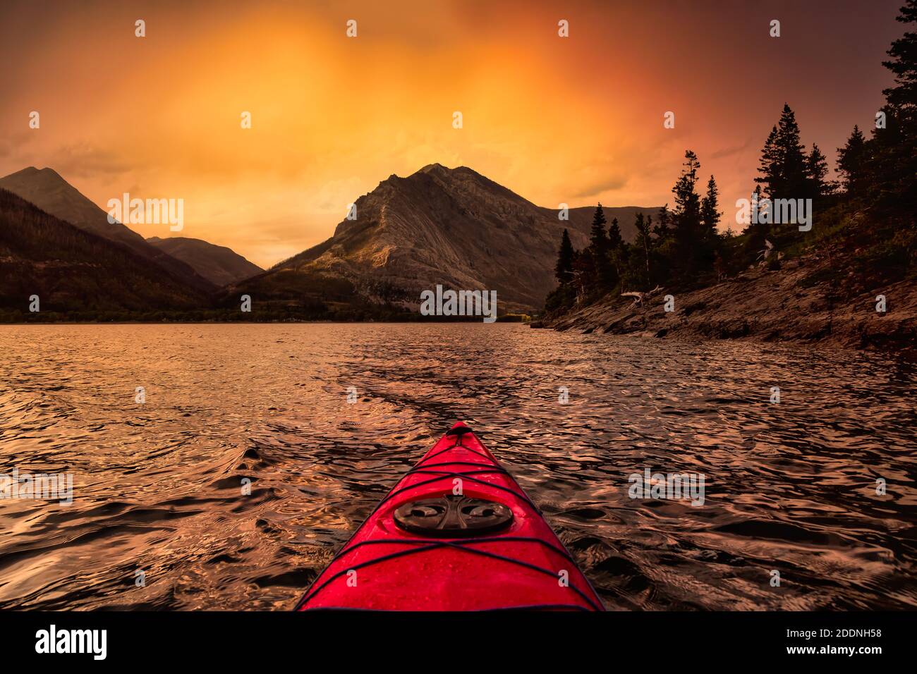 Kayaking in Glacier Lake surrounded by the beautiful Canadian Rocky Mountains Stock Photo