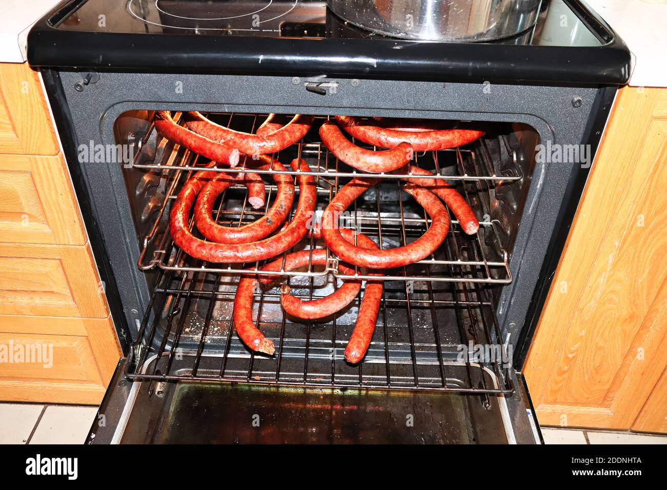 Racks of ham sausages drying in an oven Stock Photo Alamy