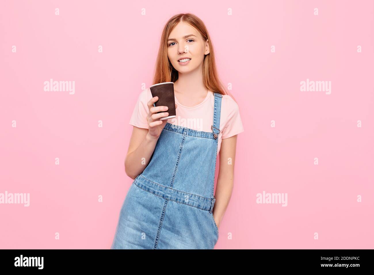 Portrait of a smiling, stylish young woman in casual clothes, posing ...