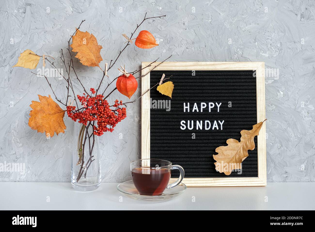 Happy Sunday Text On Black Letter Board And Bouquet Of Branches With Yellow Leaves On 
