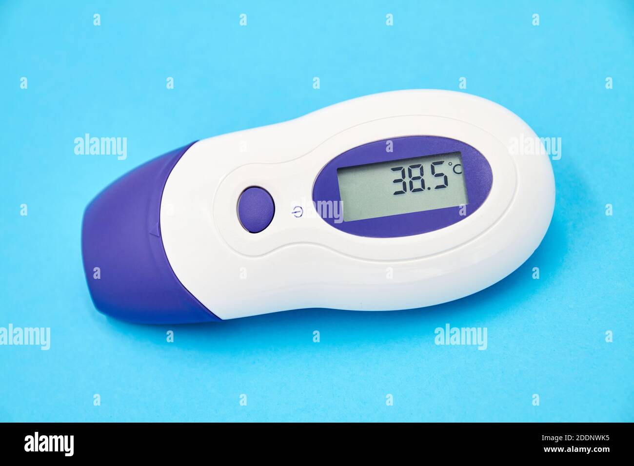 A non-contact infrared thermometer on blue background showing temperature  38.5 Stock Photo - Alamy