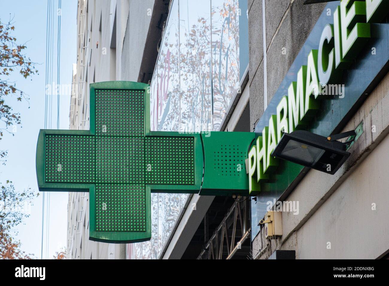Lyon (France), 24 November 2020. Green cross from a pharmacy. This symbol is also called the Greek cross. Stock Photo