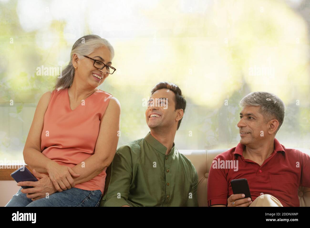 senior parents with their grown up son Stock Photo