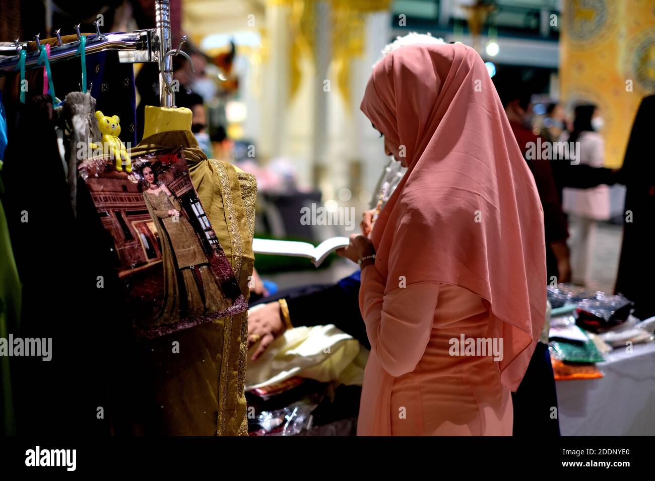 An Indian woman recording her cloth sale in shop Stock Photo - Alamy