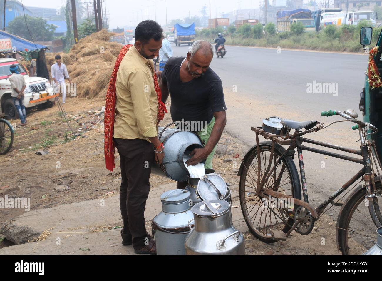 Kolkata, India. 21st Nov, 2020. A man pours milk into a can at a near