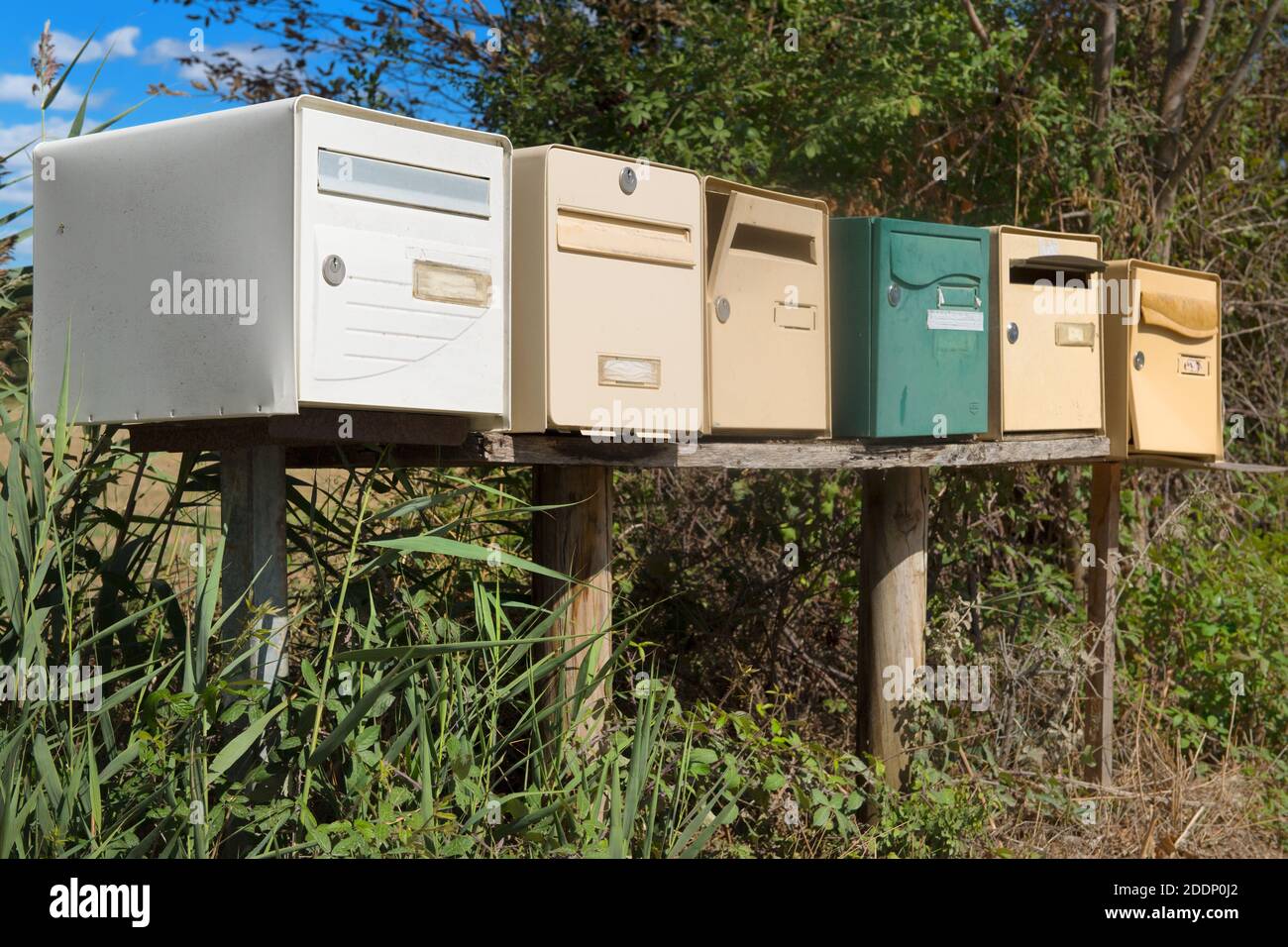 Many retro mail outdoor boxes in a row Stock Photo