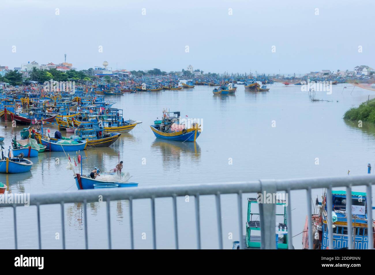 At the bridge looking at the river filled fishing boats. Stock Photo