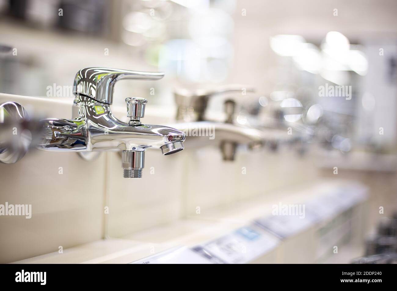 Shiny chrome basin mixer tap, plumbing installation and maintenance
