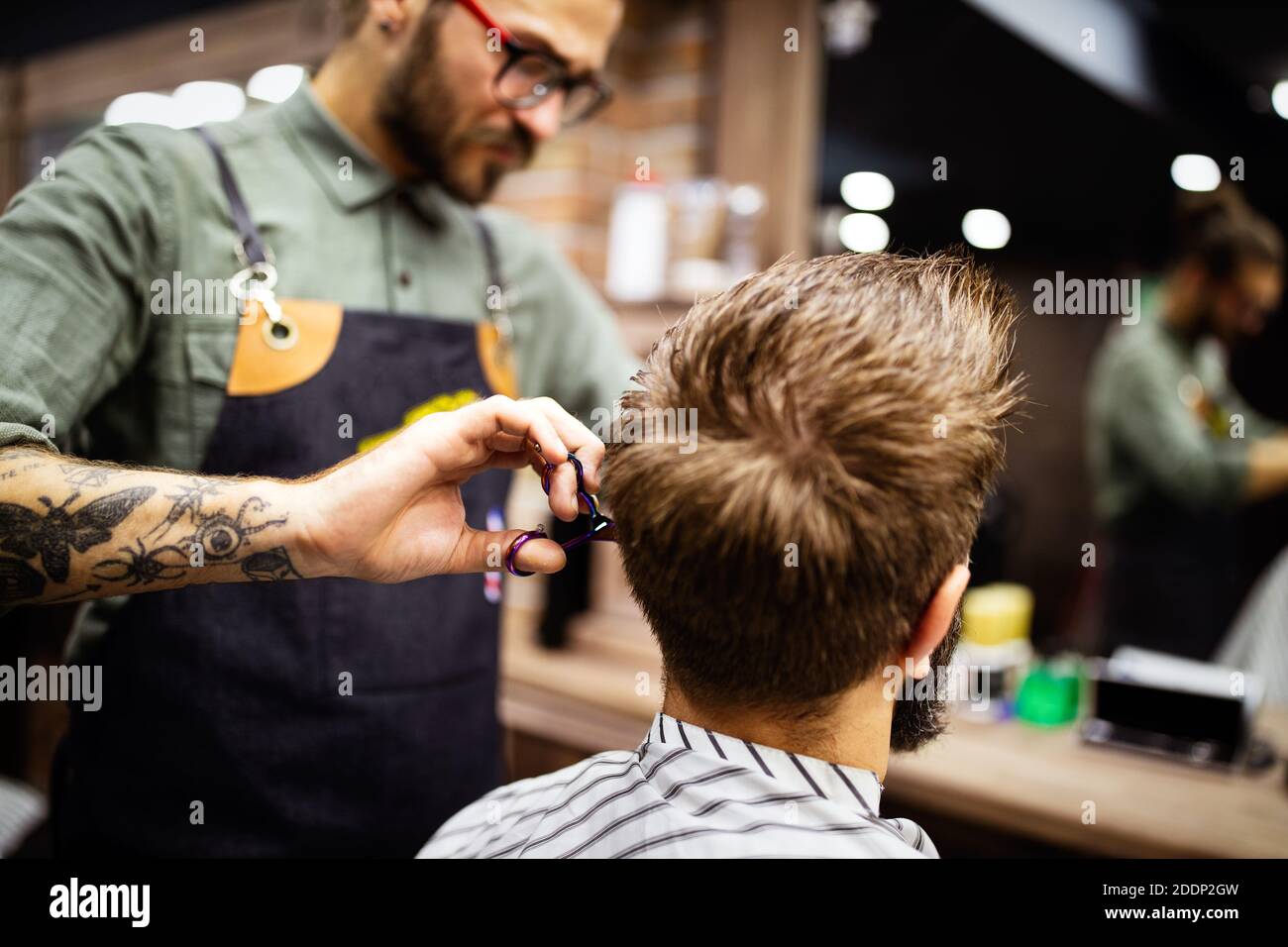 Man having a haircut with a hair clippers in salon Stock
