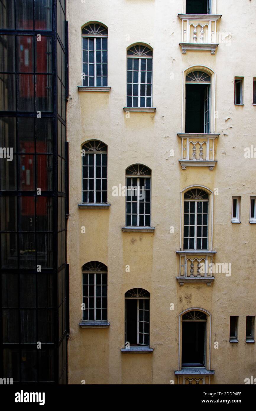 View of the front facade with multiple windows of an old tenement house in Budapest Stock Photo
