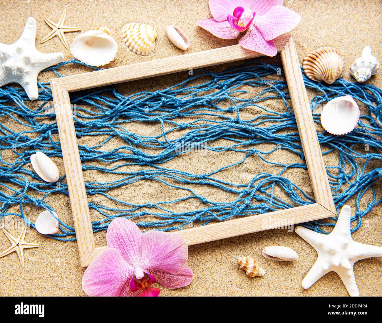 Blue Fishing net and wooden frame on a beach sand, travel, holiday ...