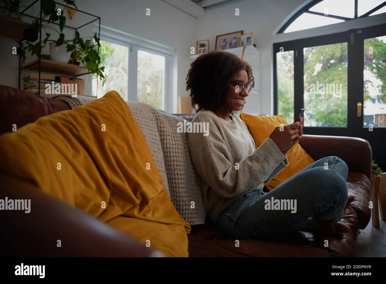 African woman sitting side view hi-res stock photography and images - Alamy