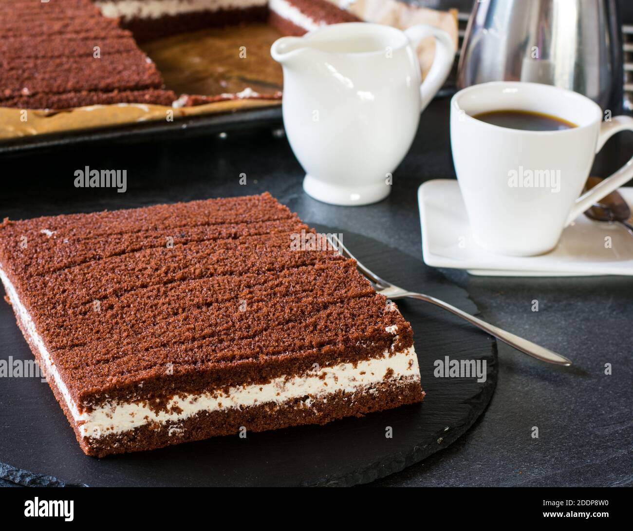 German milk slice cake with a cup of coffee Stock Photo Alamy