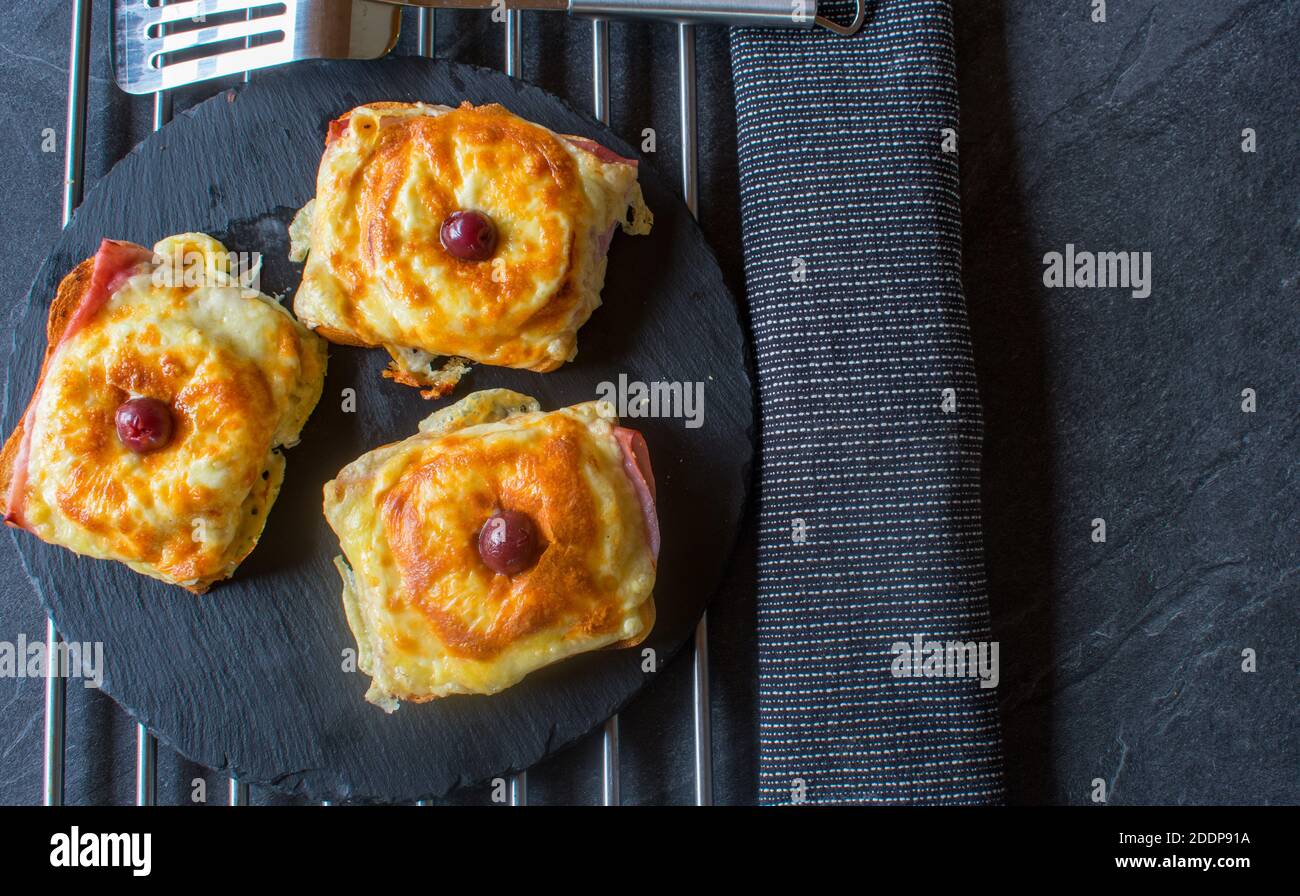 grilled toast hawaii on dark table background with copy space Stock