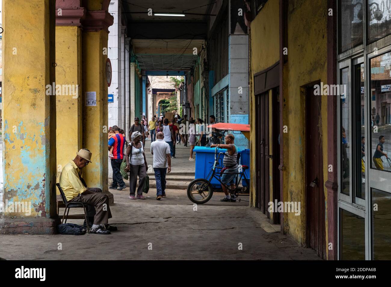 Havana,Cuba-Feb.21, 2020: Local people and tourists in Havana streets.Havana is famous with its colorful colonial buildings and cafes. Stock Photo
