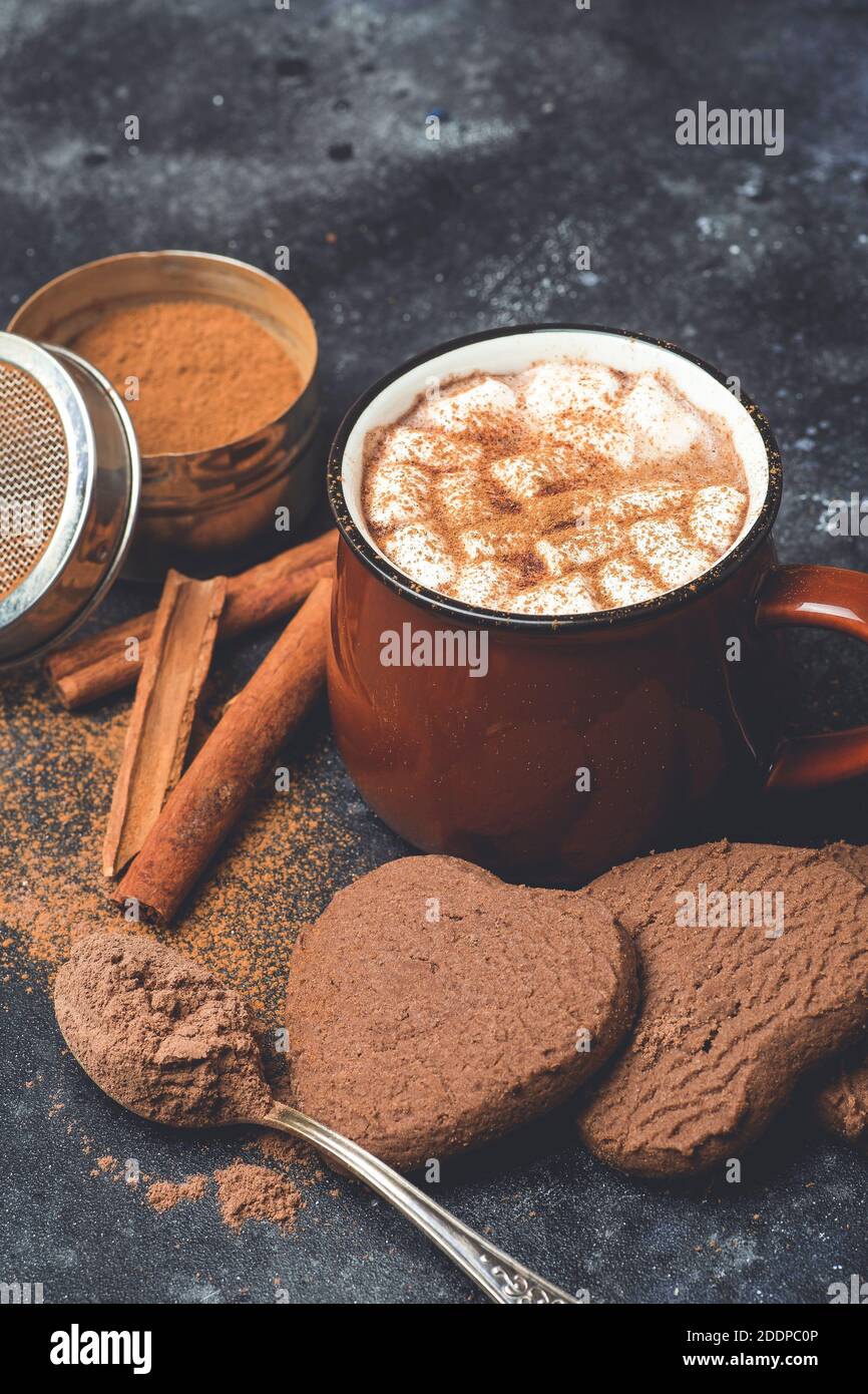 Hot chocolate (cocoa) drink backround. Cocoa drink on a dark background with cinnamon and whipping. Winter hot drinks Stock Photo