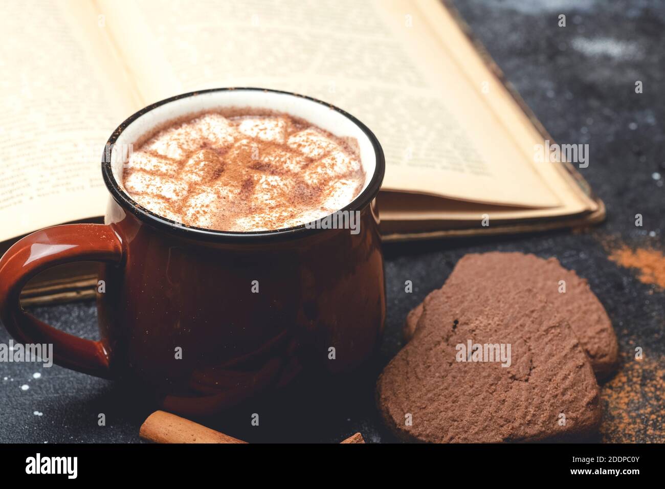 Hot chocolate (cocoa) drink backround. Cocoa drink on a dark background with cinnamon and whipping. Winter hot drinks Stock Photo