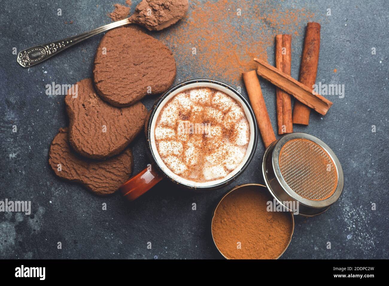 Hot chocolate (cocoa) drink backround. Cocoa drink on a dark background with cinnamon and whipping. Winter hot drinks Stock Photo
