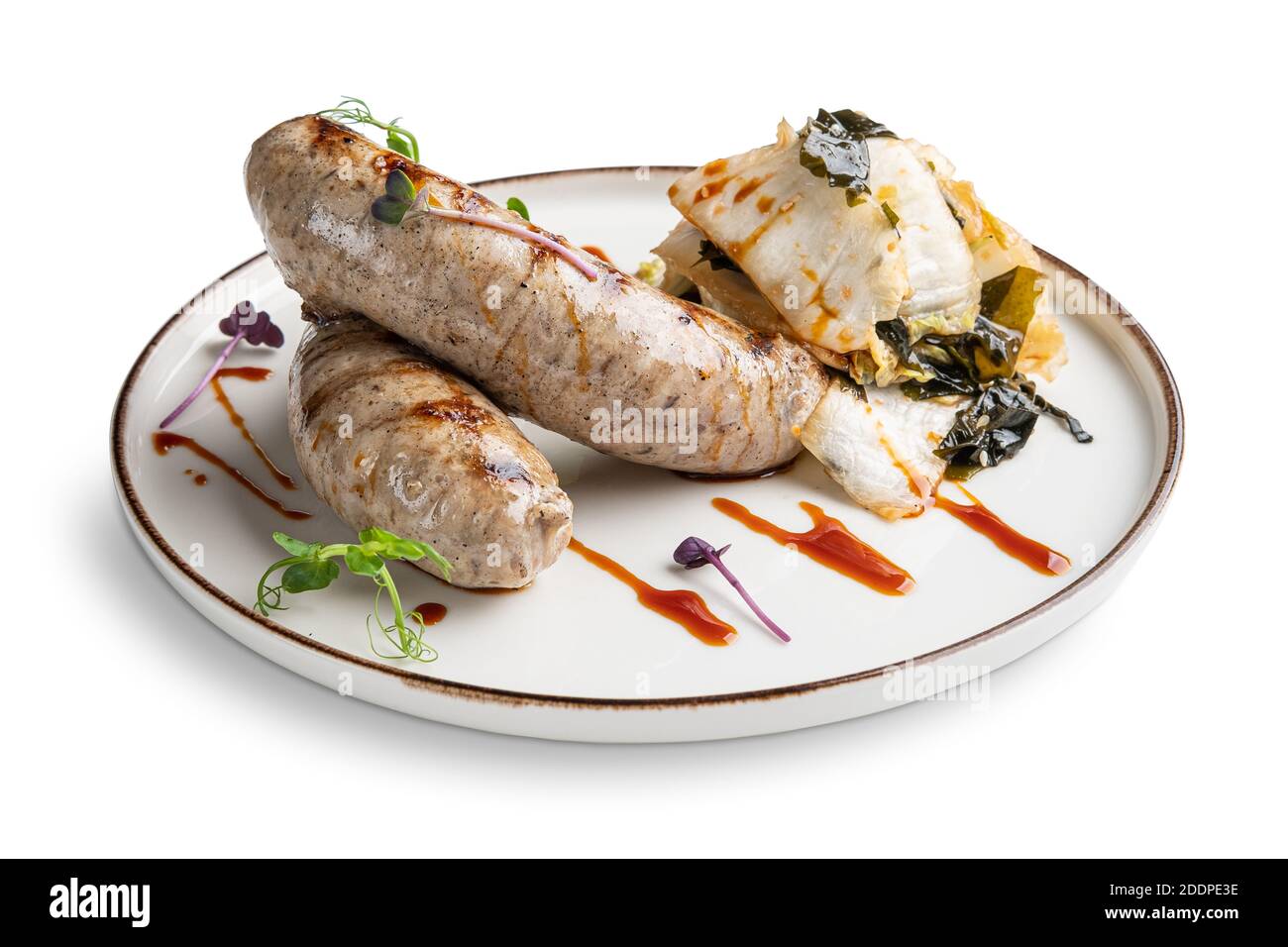 Fried Weisswurst (white veal sausage) with marinated cabbage and sea wed Stock Photo