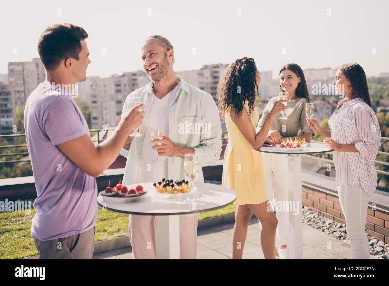 Photo of positive cheerful good mood optimistic smiling groups of friends hanging out drink champagne on rooftop Stock Photo