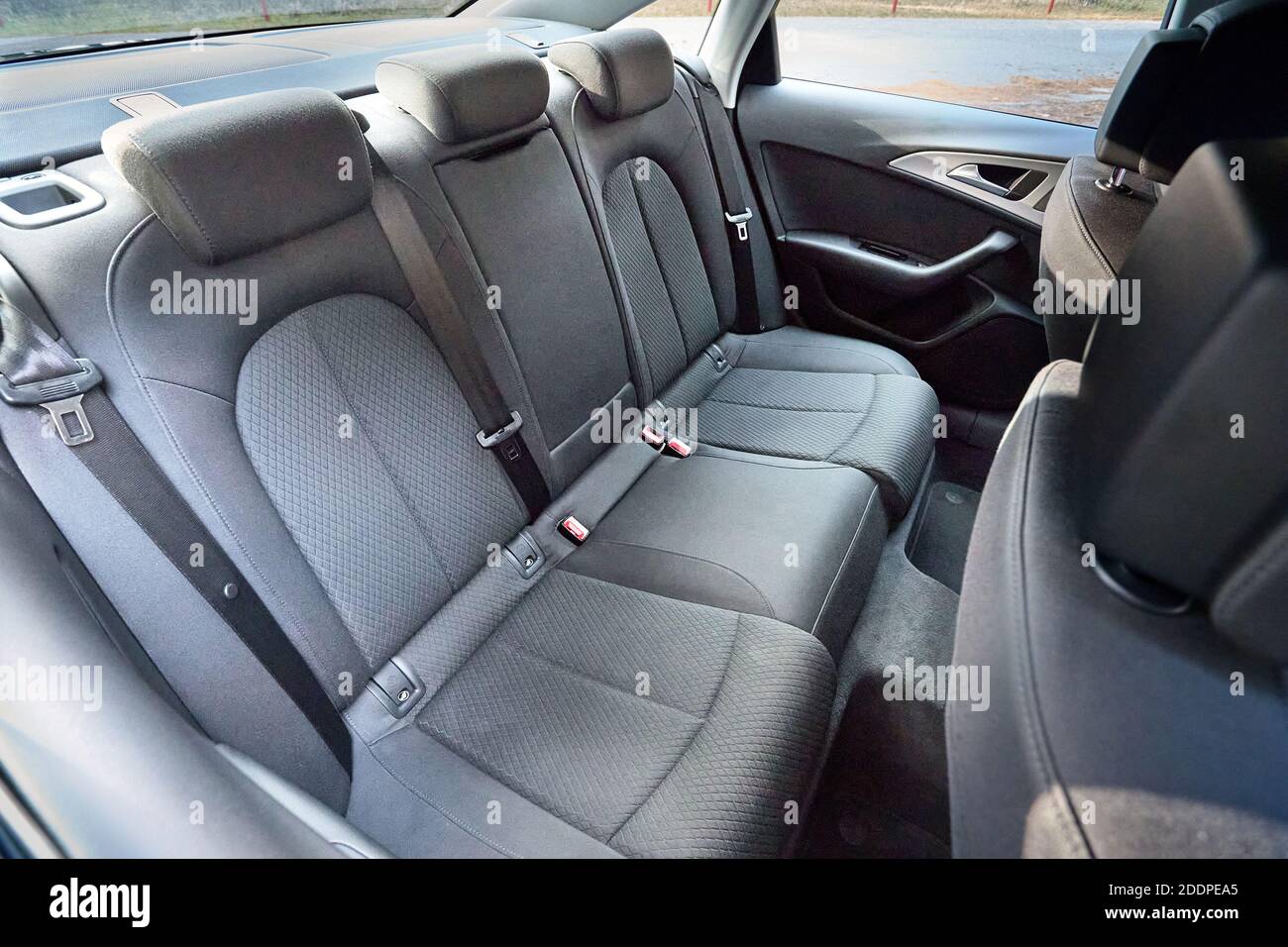GRODNO, BELARUS - DECEMBER 2019: Audi A6 4G C7 contemporary car cabin interior with rear back passenger textile seats with headrests and safety belts Stock Photo