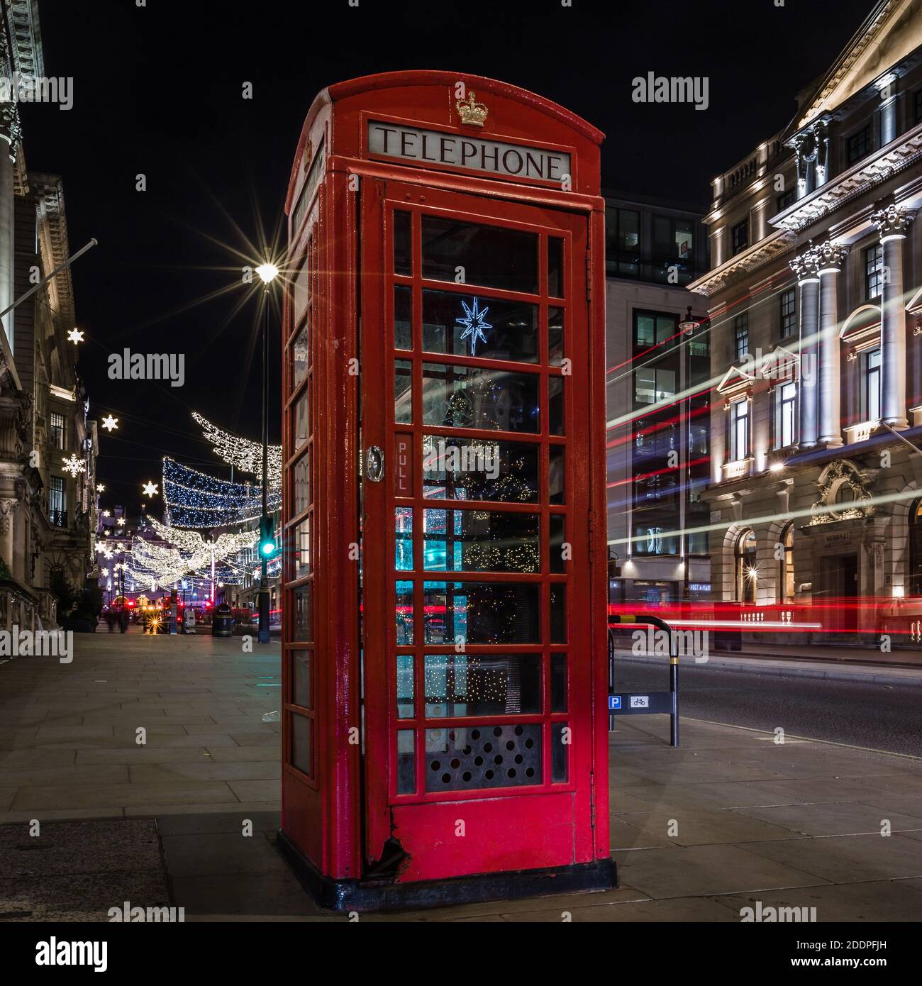 St. James christmas tree reflects on the red telephone box on lower