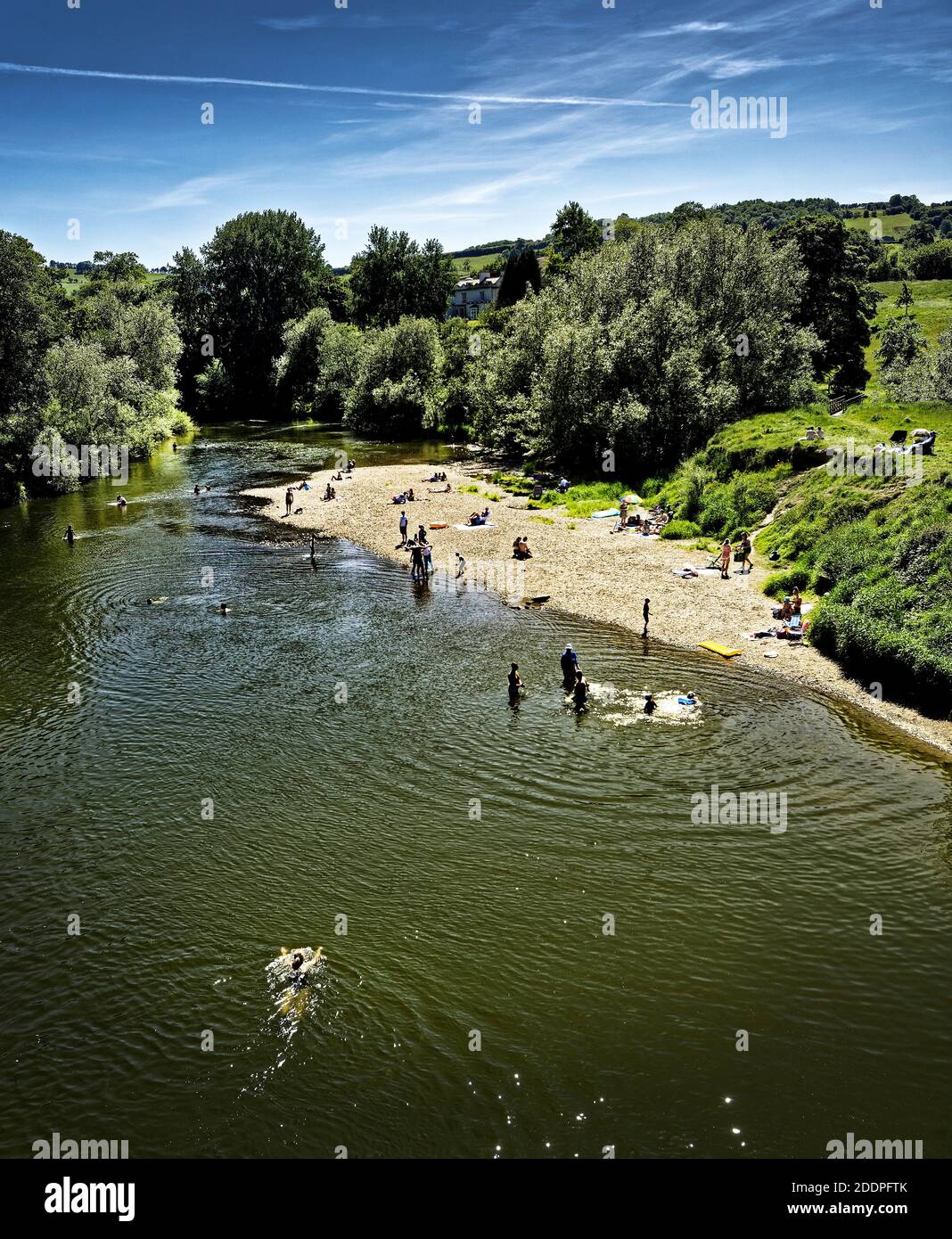 The 'beach' on the River Wye at Bredwardine is a magnet for sunbathers in hot weather Stock Photo