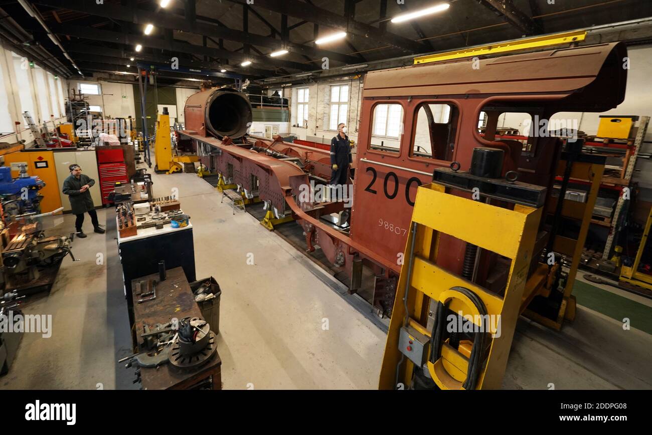 Fabricator and painter Ian Mathews (centre), 56, works on the construction of No. 2007 'Prince of Wales' steam locomotive at the A1 Locomotive Trust in Darlington, County Durham. Stock Photo