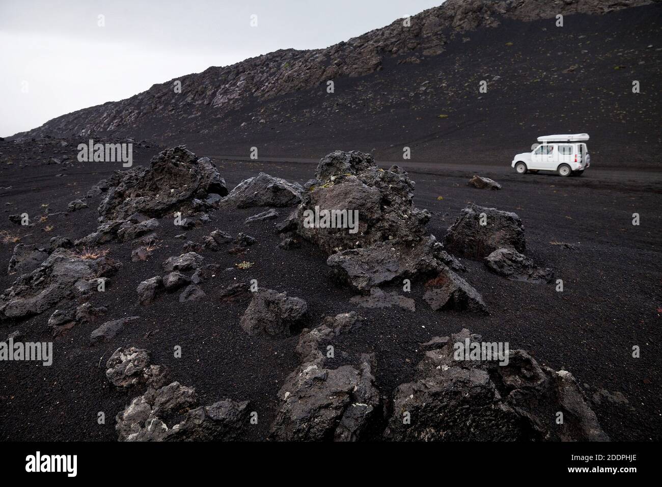 white car in black lava landscape, Iceland, Landmannaleid Stock Photo