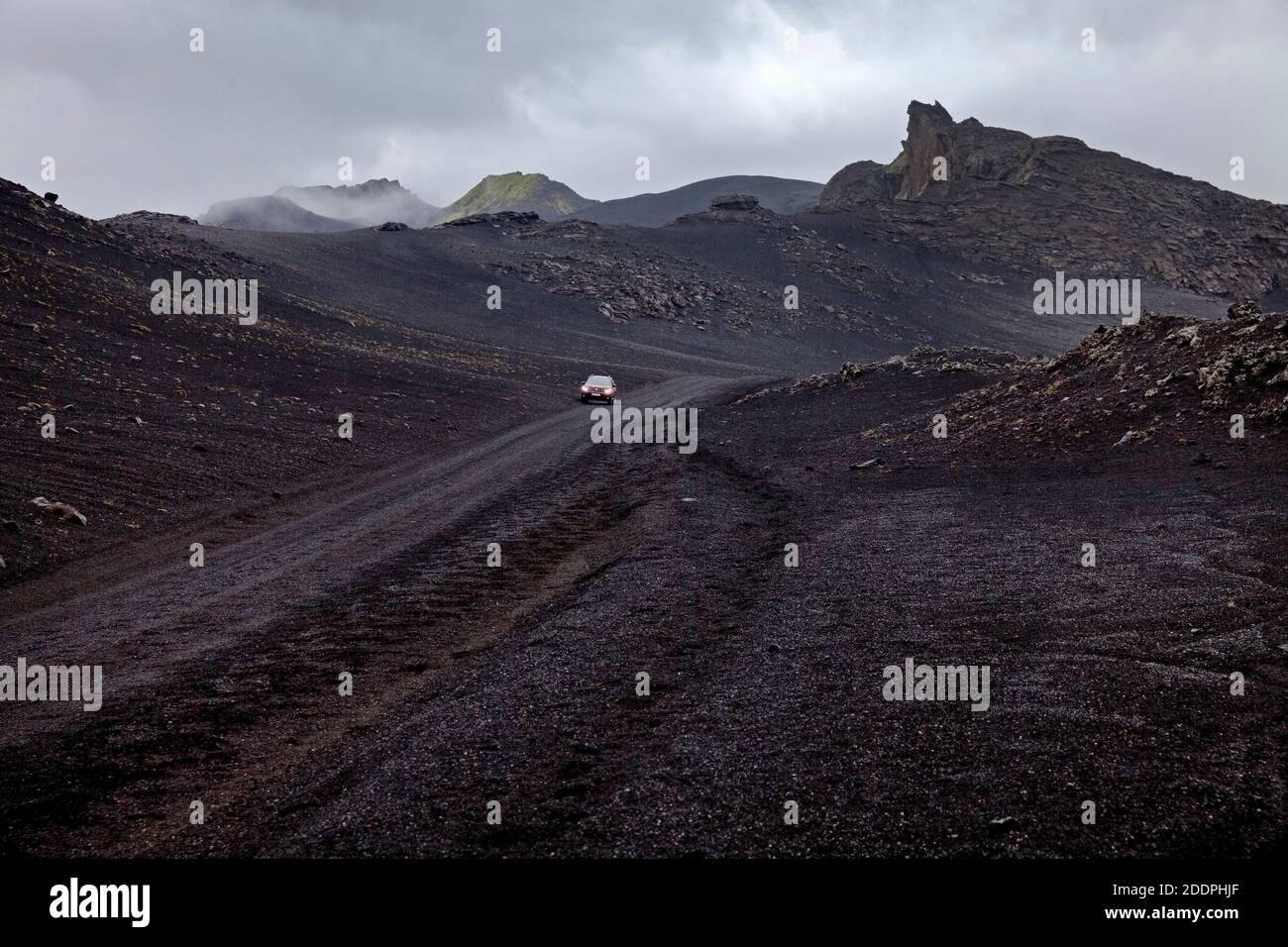 car in black lava landscape, Iceland, Landmannaleid Stock Photo