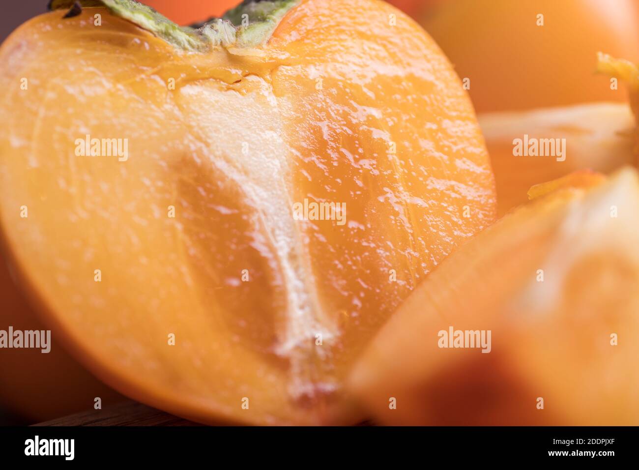 fresh ripe, orange jucy persimmons cut close-up. macro Stock Photo