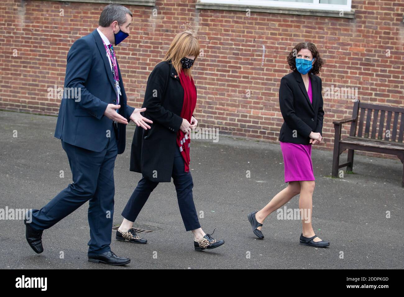 Shadow Chancellor of the Exchequer Annaliese Dodds (R) talks to Labour Croydon MP Satah Jones (M) and Head Teacher Patrick Shields (L) during a visit to St Mary's Catholic High School in Croydon, London, where she talked with teachers about the public sector pay freeze announced by Chancellor of the Exchequer Rishi Sunak. Stock Photo