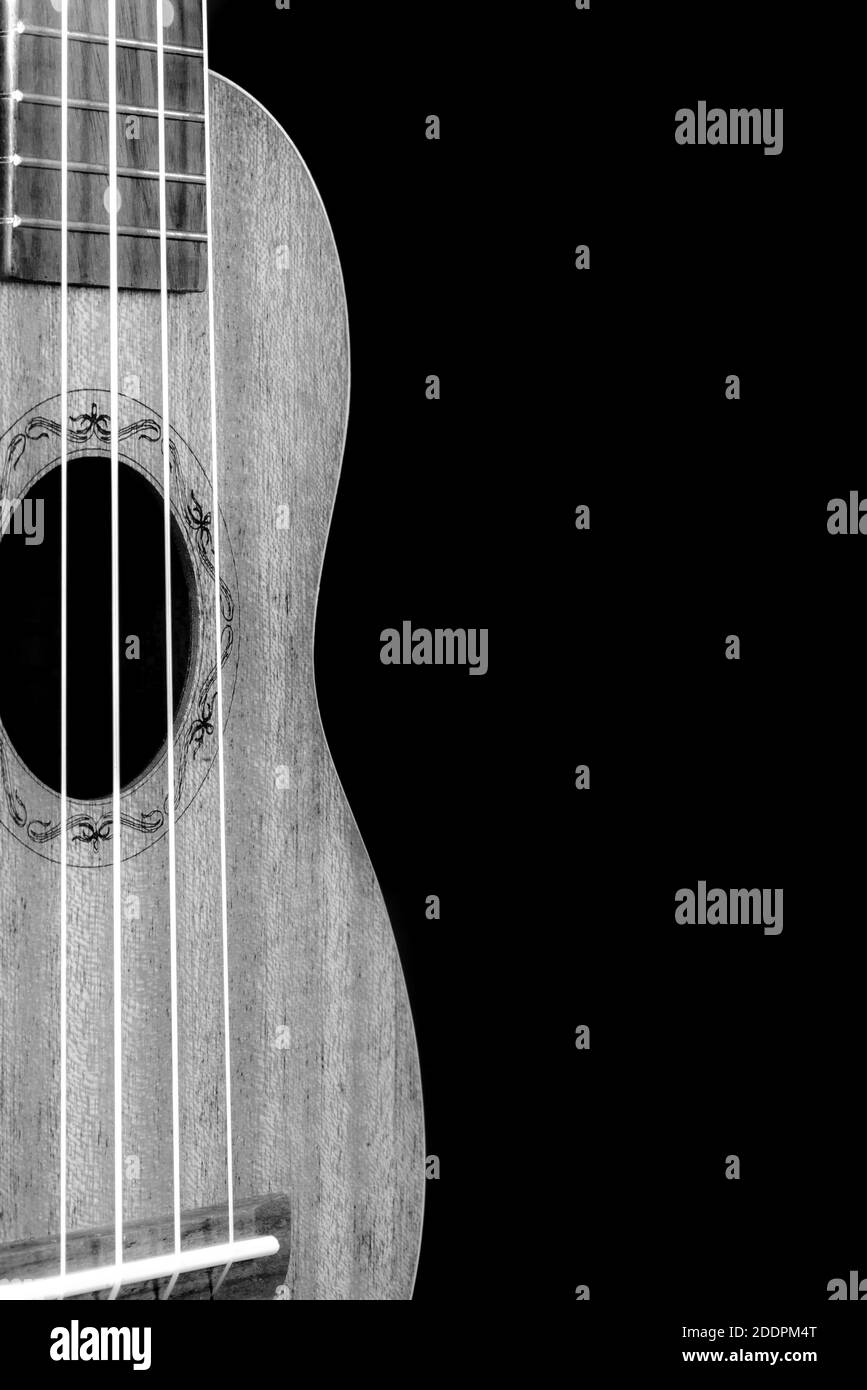 Guitar ukulele perspective view close up black and white dark background Stock Photo