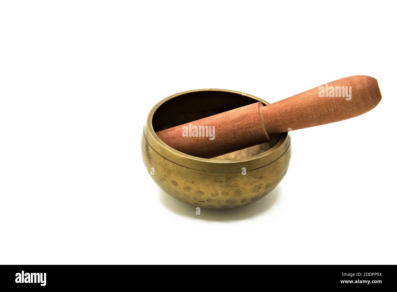 Bronze meditation singing bowl with wooden stick isolated on white background.  Stock Photo