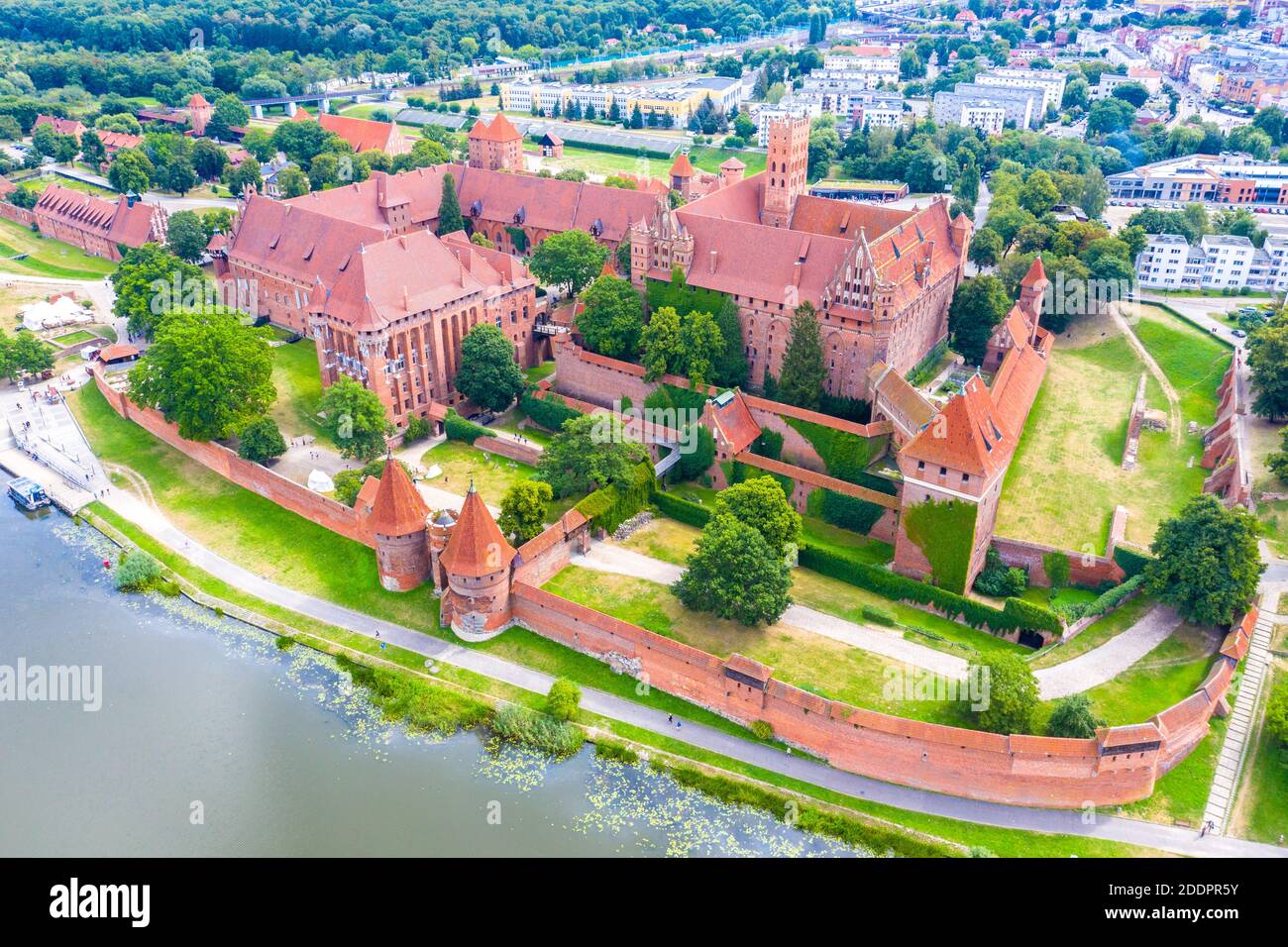 Aerial panoramic view of the gothic Grand Masters’ Palace in the High Castle part of the medieval Teutonic Order Castle by the Nogat river in Malbork, Stock Photo